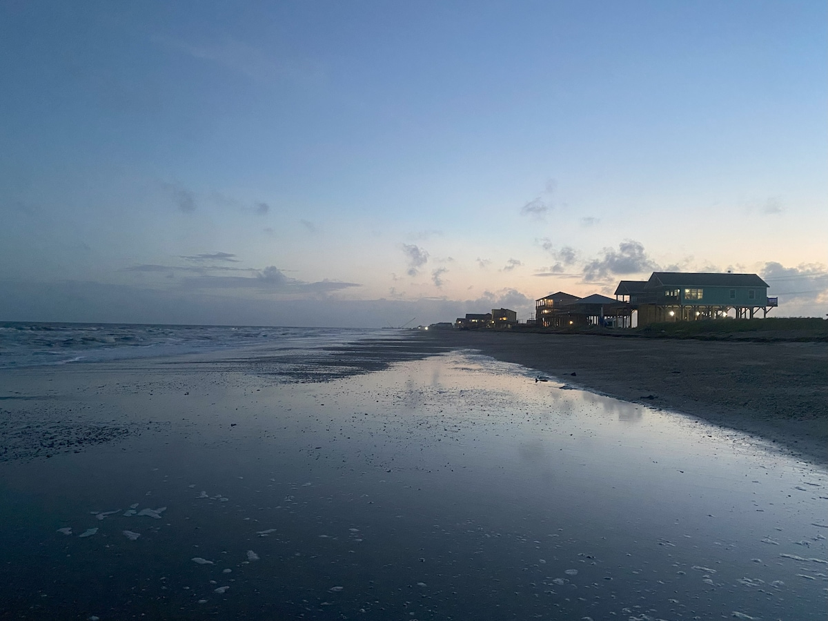 Stunning sunset over the Gulf of Mexico with Gone Fishin' beach house in the foreground